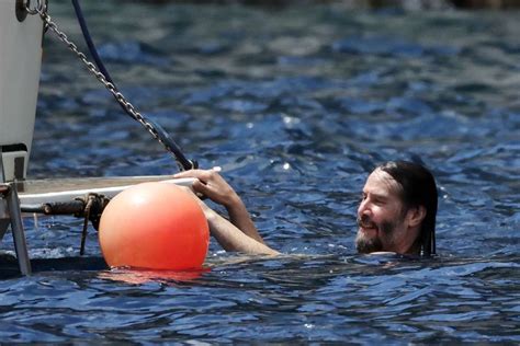 Shirtless Keanu Reeves Lounges On A Boat In Italy — See The Photos