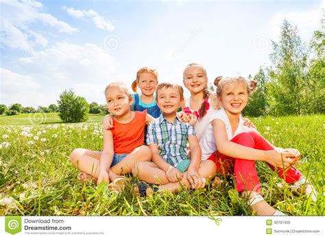 Five Kids Smile Sitting On A Grass Stock Image Image Of Children