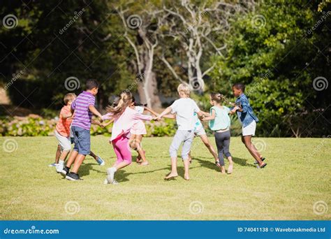 Kids Playing Together During A Sunny Day Stock Photo Image Of