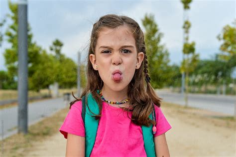 Little Girl Sticking Her Tongue Out After School By Stocksy