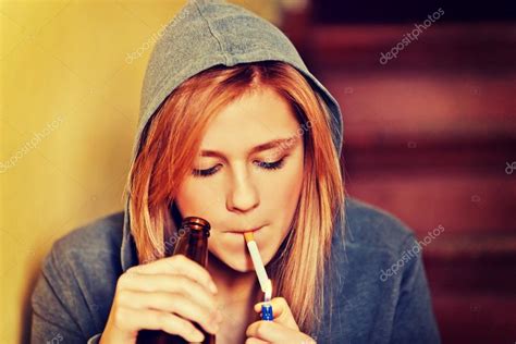 Teenage Woman Drinking Beer And Smoking Cigarette Stock Photo Piotr Marcinski