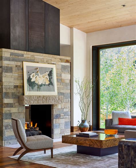 Living Room With Stone Fireplace And Floor To Ceiling Windows