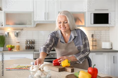 Beautiful Mature Woman Cooking In Kitchen Stock Photo Adobe Stock