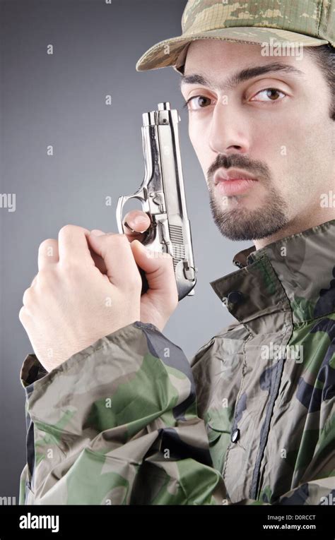 Soldier With Gun In Studio Shooting Stock Photo Alamy