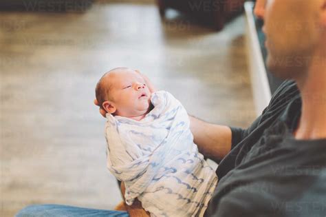 Father Holding Newborn Baby Boy Stock Photo