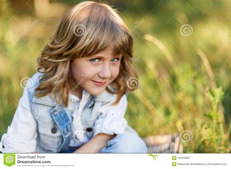 30+ men can try this curly wavy long hairstyle out. A Portrait Of A Cute Little Boy With Blue Eyes And Long ...
