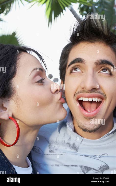 Close Up Of A Young Woman Kissing A Young Man Stock Photo Alamy