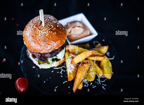 Home Made Burgers With Delicious French Fries And Spicy Mayonnaise Sauce