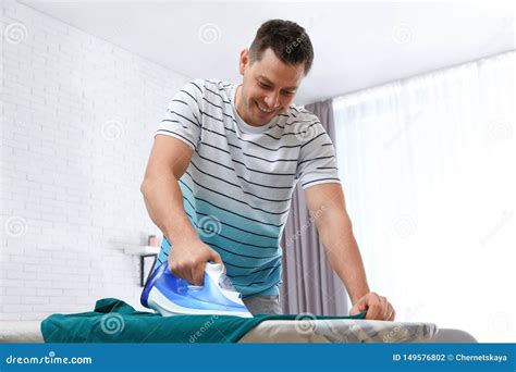 Man Ironing Clothes On Board Stock Photo Image Of Housework Heat