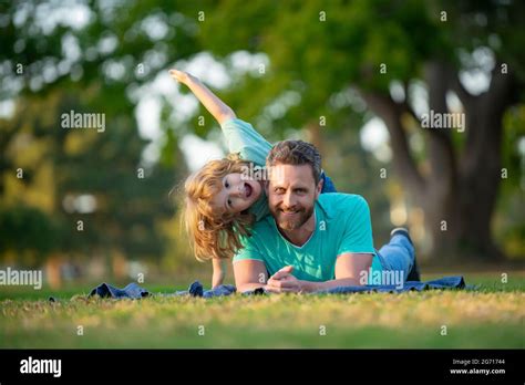 Happy Father And Son Enjoying Summer Time On Vacation In A Sunny Park Concept Of Healthy