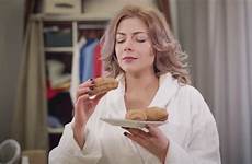 croissant caucasian enjoying biting bathrobe smelling tasty