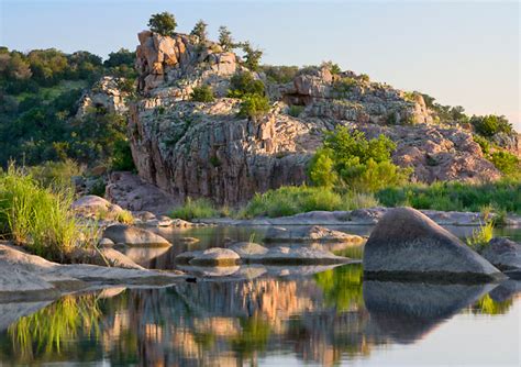 Sunset Behind Large Rock Formations Along The Llano River In The Texas