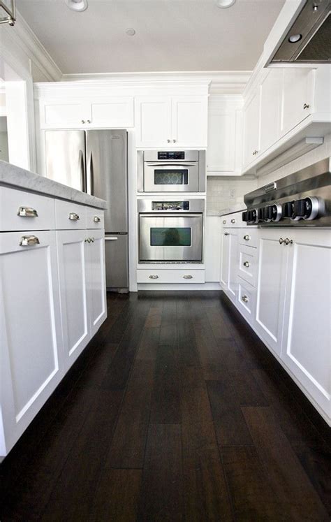 When paired with light wood flooring, it. Our Kitchen Before/After | Dark wood kitchens, Wood floor kitchen, Hardwood floors dark