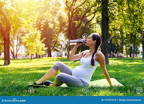 Sportive Pregnant Woman Drinking Water In Park Stock Photo Image Of