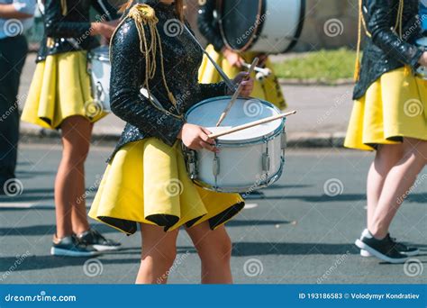 Majorettes And Marching Band Young Girls Drummer At The Parade Street