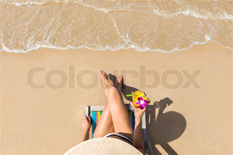 Woman At Beautiful Beach Sitting On Chaise Lounge Stock Image Colourbox