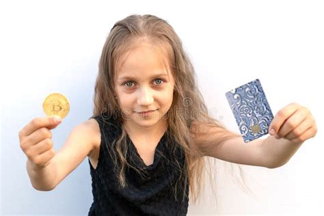 Little Girl Holding Bitcoin And A Bank Card The Choice Stock Photo