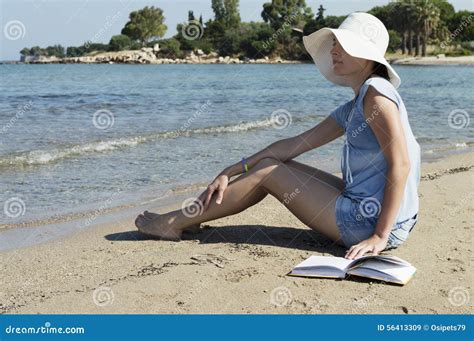 Woman Sitting On A Beach And Holding A Book Stock Image Image Of