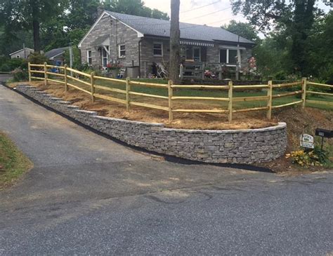 This is a more common agricultural fence, seen here marking the boundary of a bright green meadow a simple farmhouse with low maintenance landscaping including a well aged split rail fence no more than 3 feet high. Split Rail Fencing | Motta's Landscaping | Lebanon PA