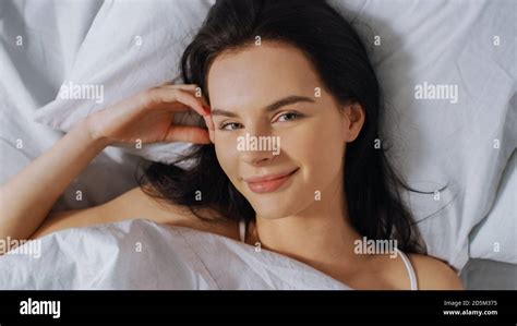 Portrait Of Beautiful Young Brunette Charmingly Sleeping In Her Bed At