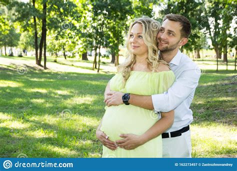 the husband hugs his pregnant wife in the park stock image image of care husband 162273457