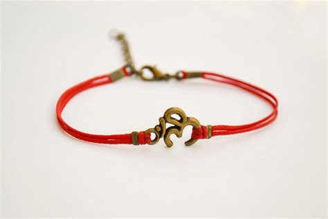 Om Bracelet Red Bracelet With Bronze Tone Om Charm Hindu Etsy Om
