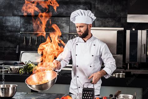 Chef Cook Food With Fire At Kitchen Restaurant Cook With Wok At