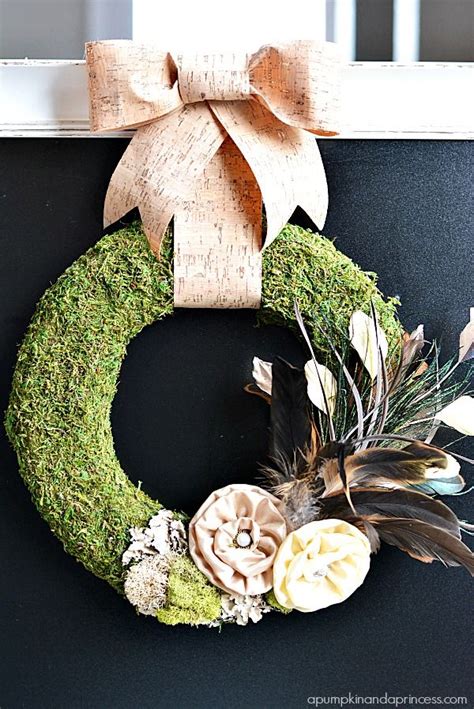 Diy Moss Wreath With Feathers And Fabric Flowers