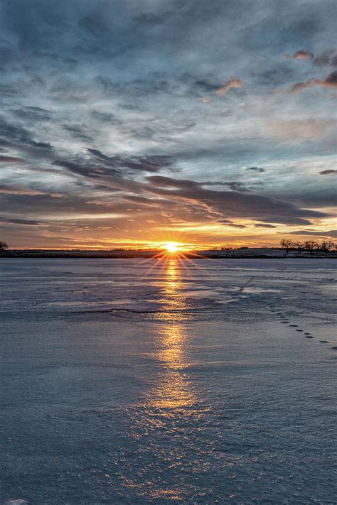 Portrait Of Starburst Sunrise Across A Frozen Lake Photograph By Tony Hake