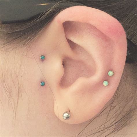 Surface Tragus Piercing With Peacock Blue Opals Piercings Tragus