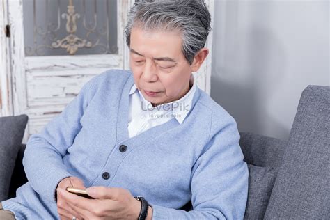 Grandpa Plays With His Cell Phone At Home Picture And Hd Photos Free Download On Lovepik
