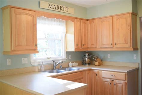 Other paint colors that would look beautiful with honey oak wood trim are warm grays with green or bronze undertones. Wall Colors for Honey Oak Cabinets - Love Remodeled