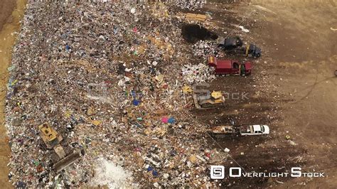 Overflightstock™ Garbage Trucks Unloading At The Urban Dump Landfill