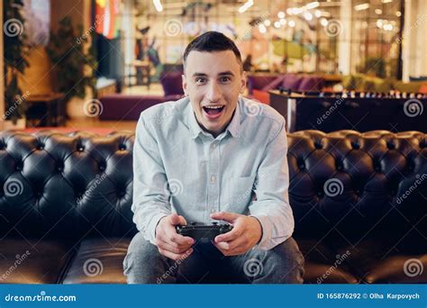 A Man Plays Games Holds A Joystick In His Hands A Console Game A Guy
