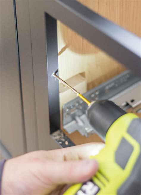 Anchor the island cabinets to the 2x2s with screws. How to Install Kitchen Cabinets Yourself - Cherished Bliss