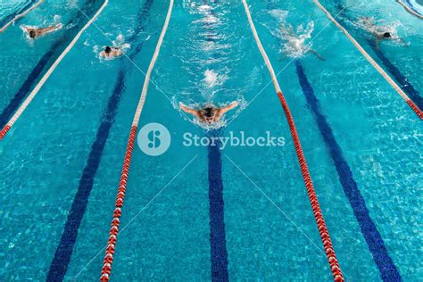 Five Male Swimmers Doing The Butterflies Stroke While Racing Against