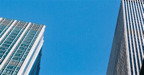 Contemporary Skyscrapers Under Cloudless Sunny Blue Sky · Free Stock Photo