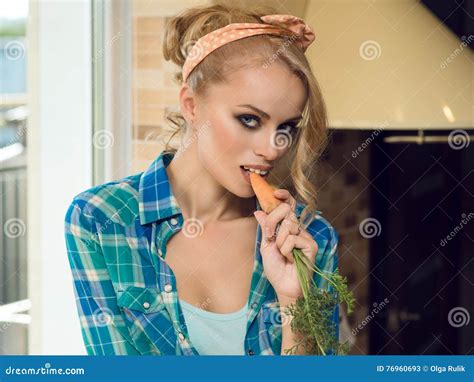 Beautiful Seductive Blond Housewife Eating Carrot In The Kitchen Stock Image Image Of