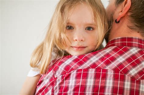 Premium Photo Little Sad Girl On Dads Arms Daughter Hugs Dad