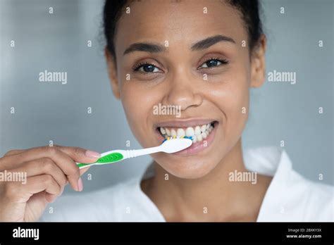 Close Up African American Young Woman Brushing Healthy Teeth Stock