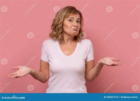 Clueless Mature Woman Shrugging Helpless With Her Shoulders Stock
