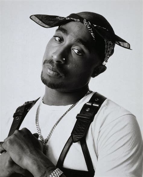 A Black And White Photo Of A Man Wearing A Bandana With His Eyes Closed