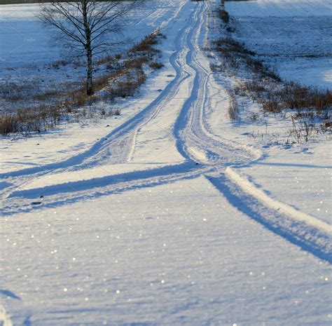Track On A Snowcovered Road Containing Snow Covered And Road