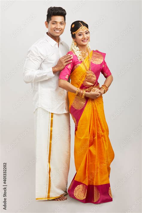Attractive Happy South Indian Couple In Traditional Dress On White