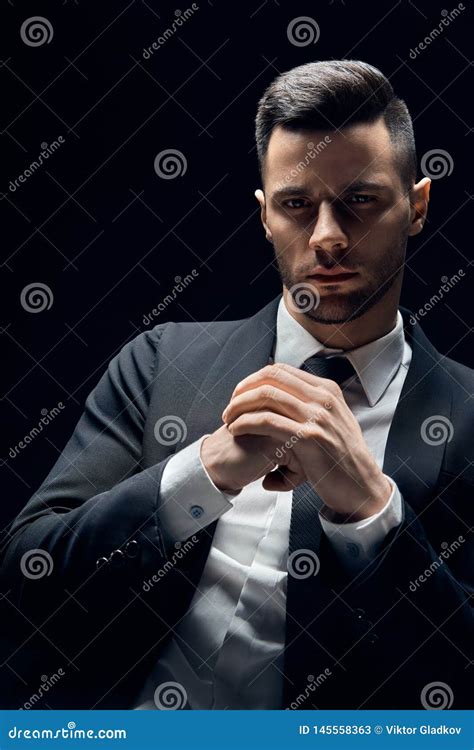 handsome thoughtful man in black suit on dark background stock image image of elegant