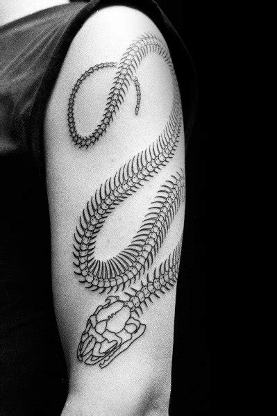 Skeleton tattoo represents the pure essence of a person. 30 Snake Skeleton Tattoo Ideas For Men - Bone Designs