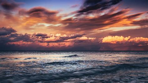 Download Wallpaper 2048x1152 Sea Sunset Waves Clouds Dusk Ultrawide