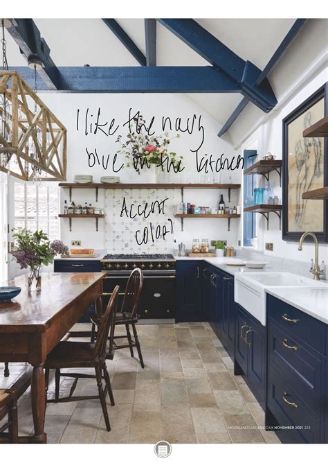 A Kitchen With Blue Cabinets And White Walls