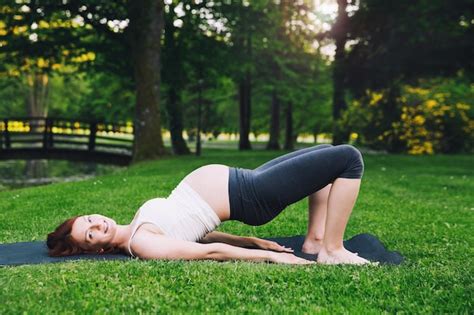premium photo beautiful pregnant woman doing prenatal yoga on nature outdoors