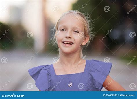Cute Little Caucasian Girl Seven Years Old With Blonde Hair Smiling